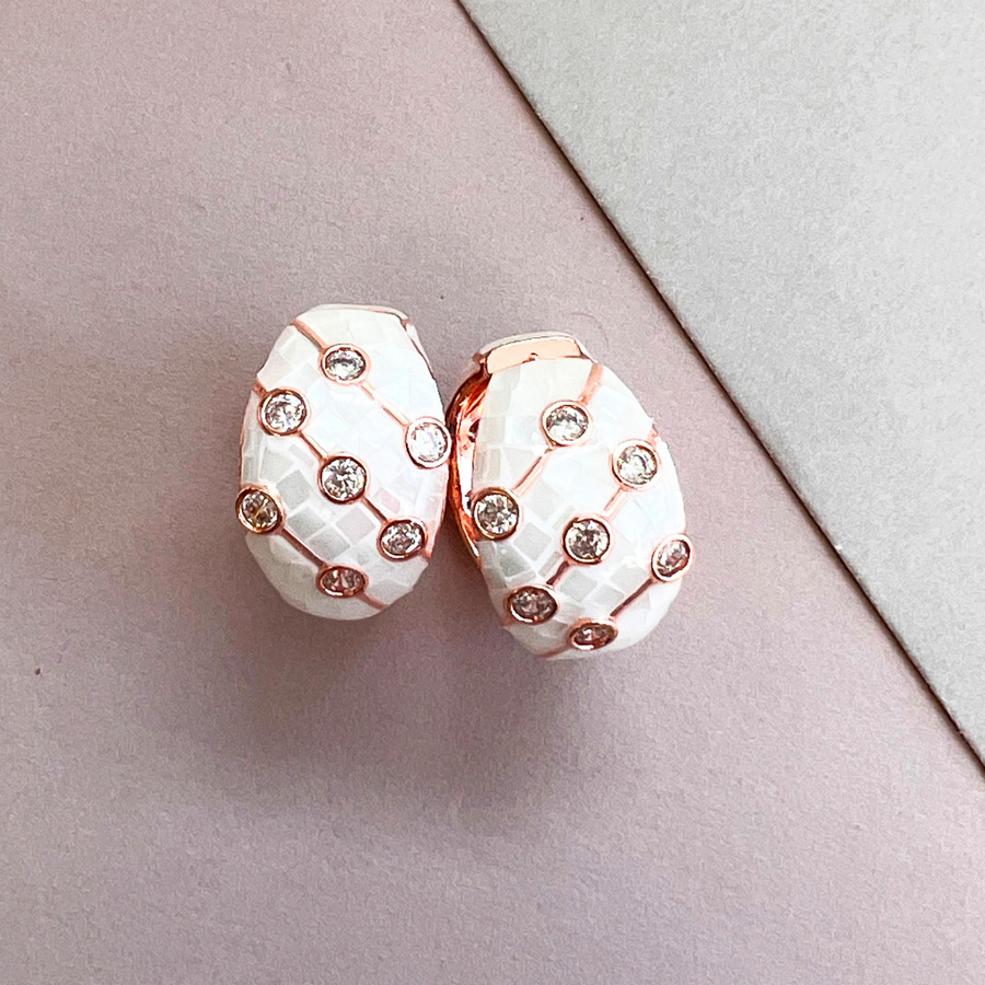 A pair of elegant white and rose gold earrings, perfect for adding a touch of sophistication to any outfit.