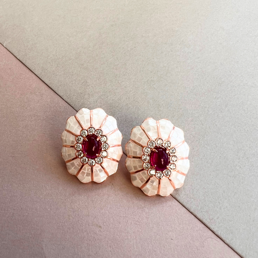 A pair of delicate flower-shaped earrings in pink and white, adding a touch of elegance to any outfit.
