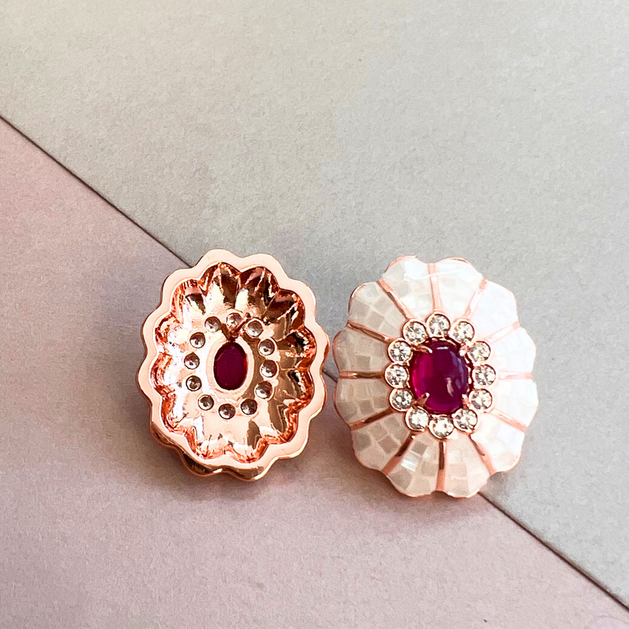 A pair of delicate flower-shaped earrings in pink and white, adding a touch of elegance to any outfit.