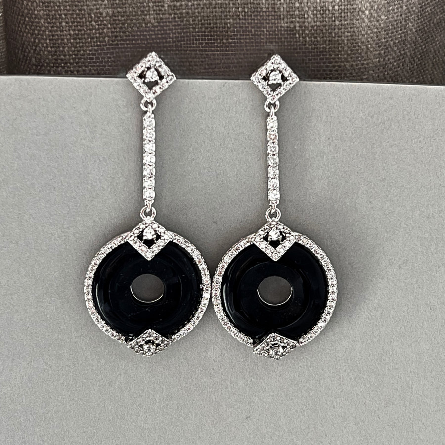 Black and white diamond earrings, a stunning pair of contrasting gems that exude elegance and sophistication.