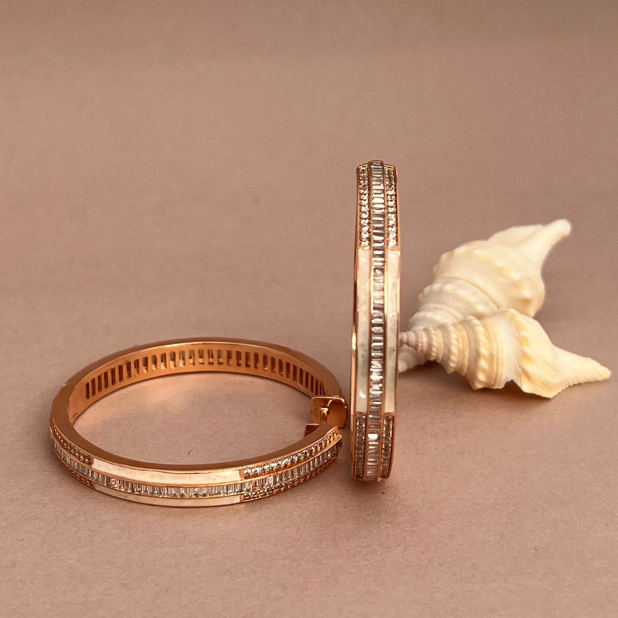 Luxurious rose gold bracelets adorned with shimmering diamonds along the edges.