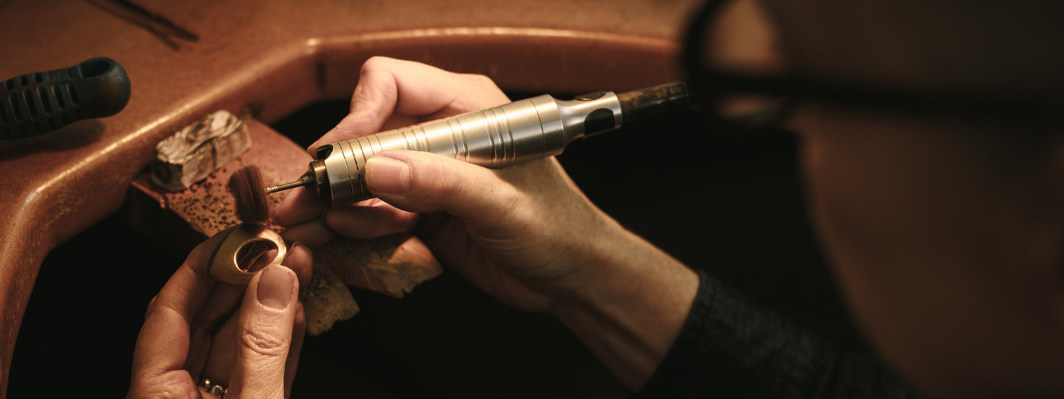 Jewelry artisan polishing a gold ring in a Dubai studio, representing craftsmanship and design value behind fine jewelry — Adrisya jewelry blog 2026 by Shabnam Bhojwani.