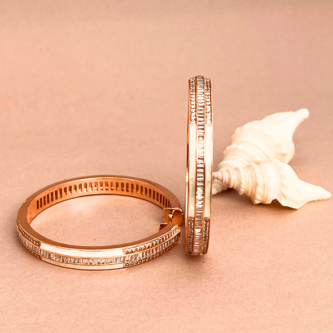 Two elegant rose gold bangles adorned with sparkling diamonds.