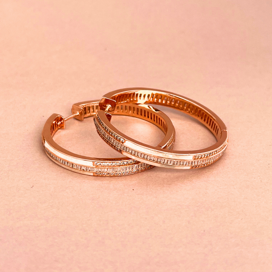 Two elegant rose gold hoop earrings with sparkling diamonds.