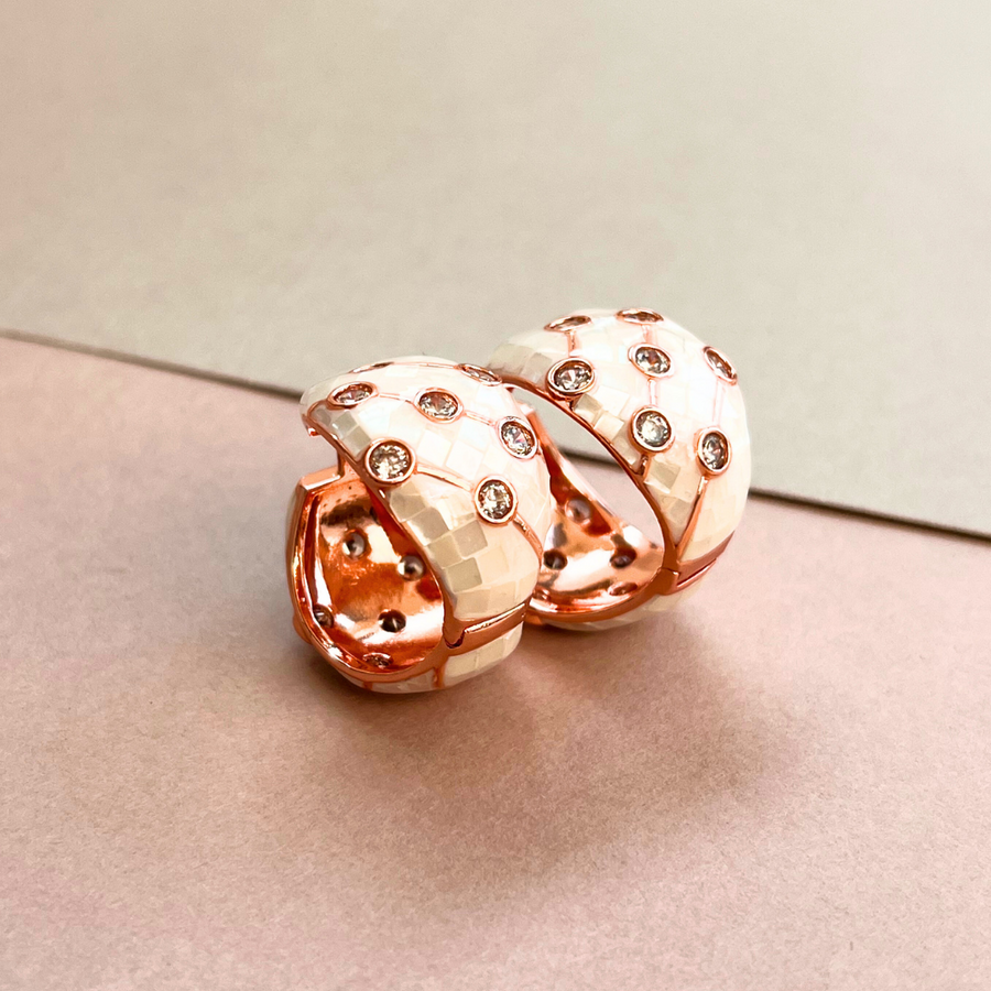 Two elegant earrings with white and pink crystals, perfect for adding a touch of sparkle to any outfit.