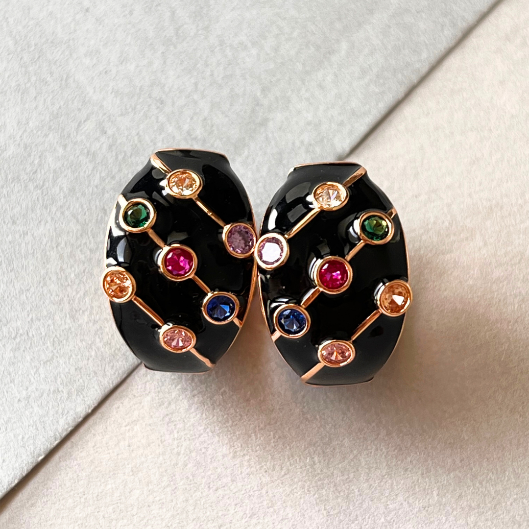 Black and gold hoop earrings with vibrant multi-colored stones.