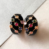 Black and gold hoop earrings with vibrant multi-colored stones.