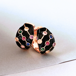 Black and gold hoop earrings with vibrant multi-colored stones.