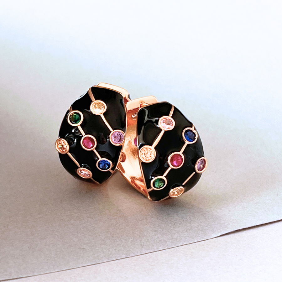 Black and gold hoop earrings with vibrant multi-colored stones.