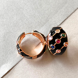 Black and gold hoop earrings with vibrant multi-colored stones.