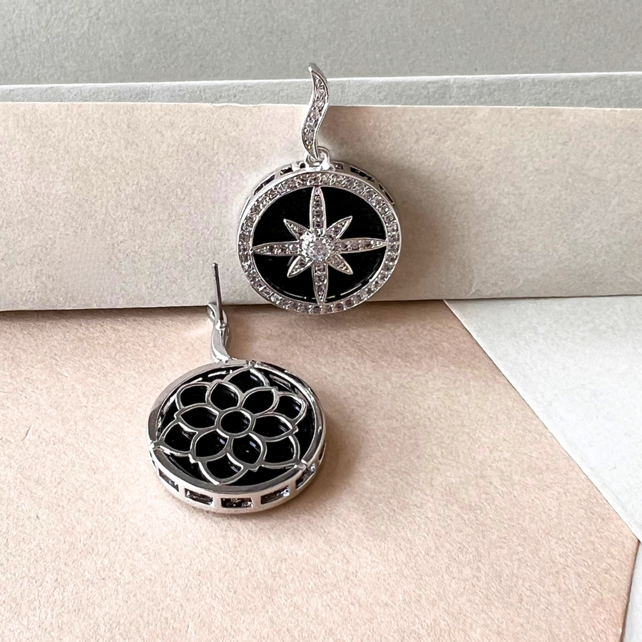 Fashionable black and white earrings with a star and compass pattern, a must-have for any jewelry collection.