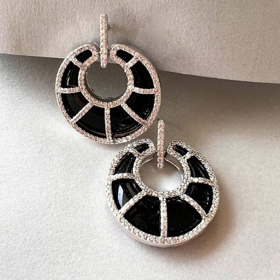 Chic black and white diamond earrings, a timeless accessory for a classic look.