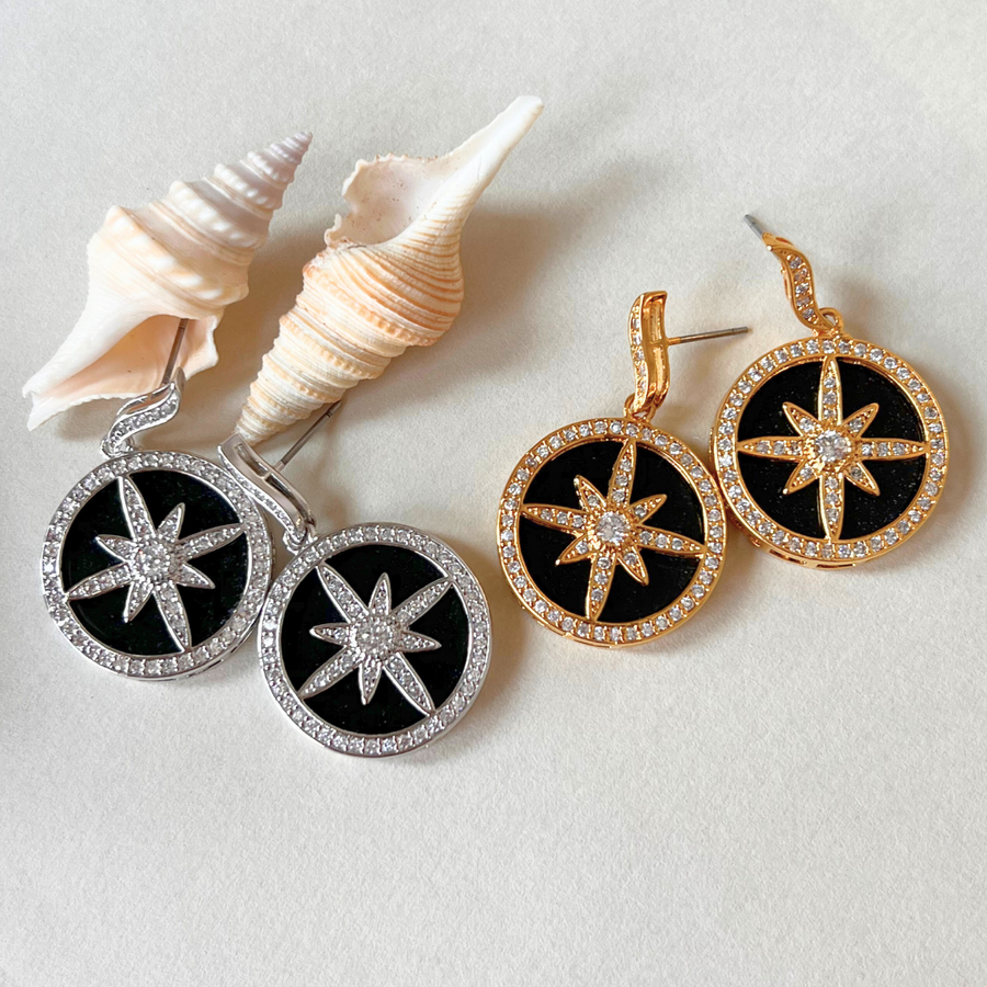 A pair of earrings featuring a star design, adding a touch of elegance and charm to any outfit.