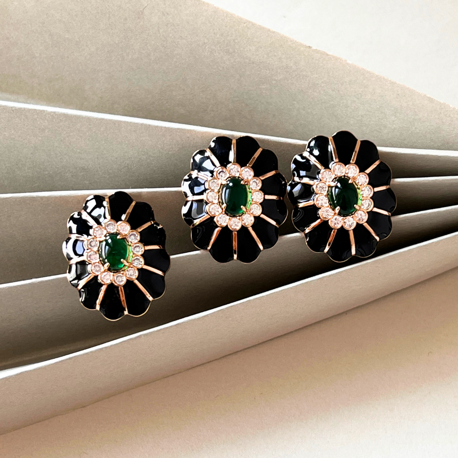 Three elegant earrings with black and green hues, adorned with sparkling diamonds for a touch of glamour.