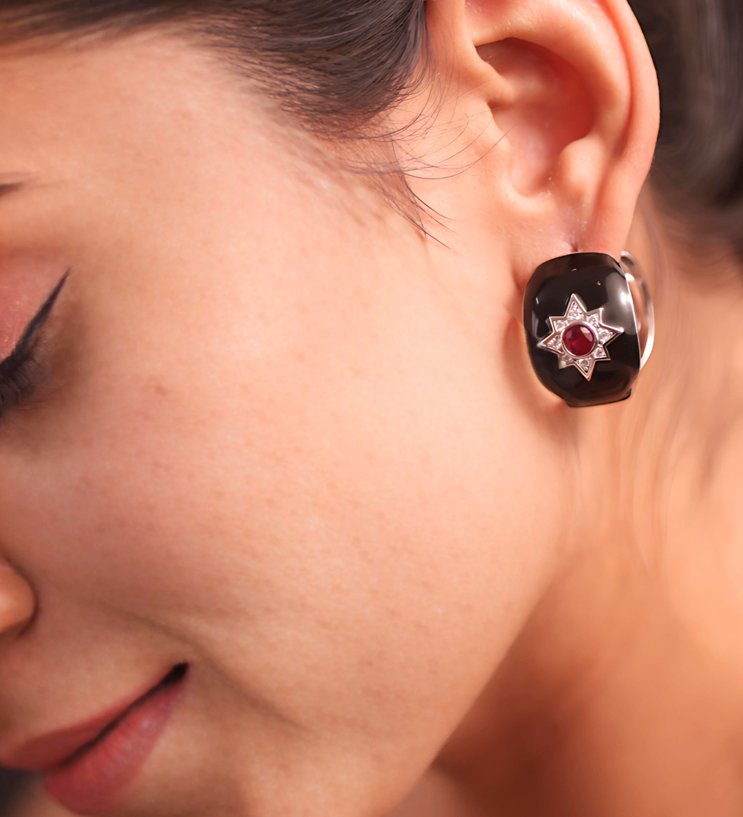 A woman wearing elegant earrings, adding a touch of sophistication to her overall appearance.