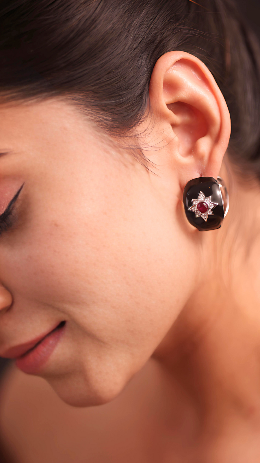 A woman wearing elegant earrings, adding a touch of sophistication to her overall appearance.