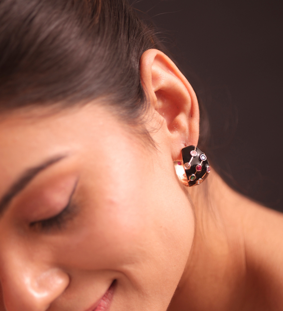 A woman in a purple dress and adrisya earrings, looking elegant and stylish.