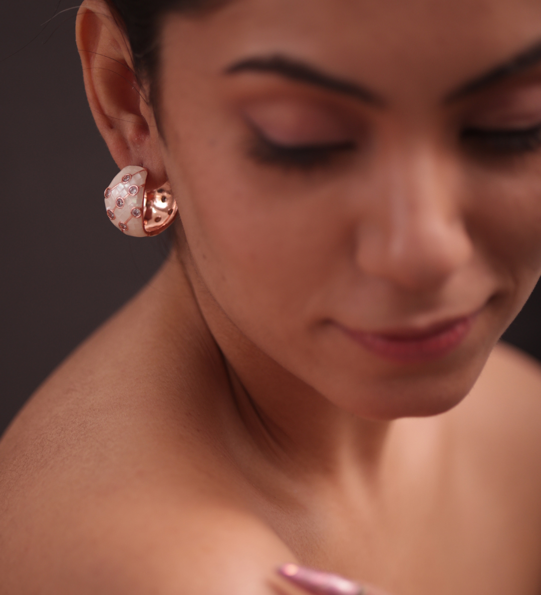 Lady in pink attire with showcasing the adrisya earrings.