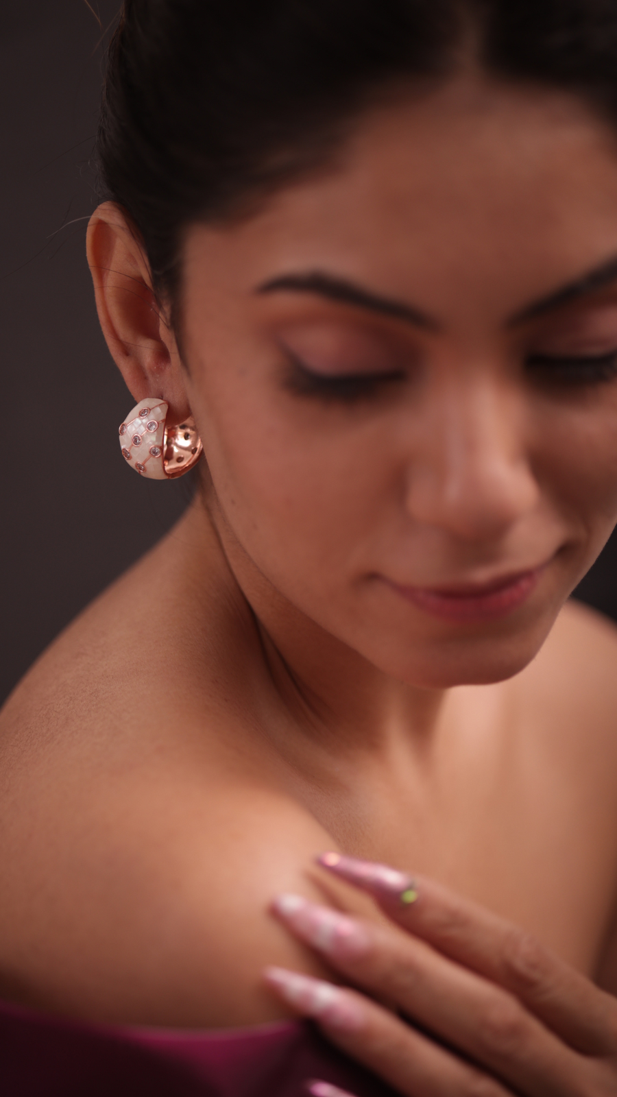 Lady in pink attire with showcasing the adrisya earrings.