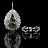 Teardrop-shaped gemstone pendant with diamond accents on a black background