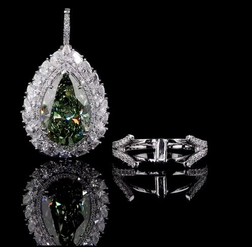 Teardrop-shaped gemstone pendant with diamond accents on a black background