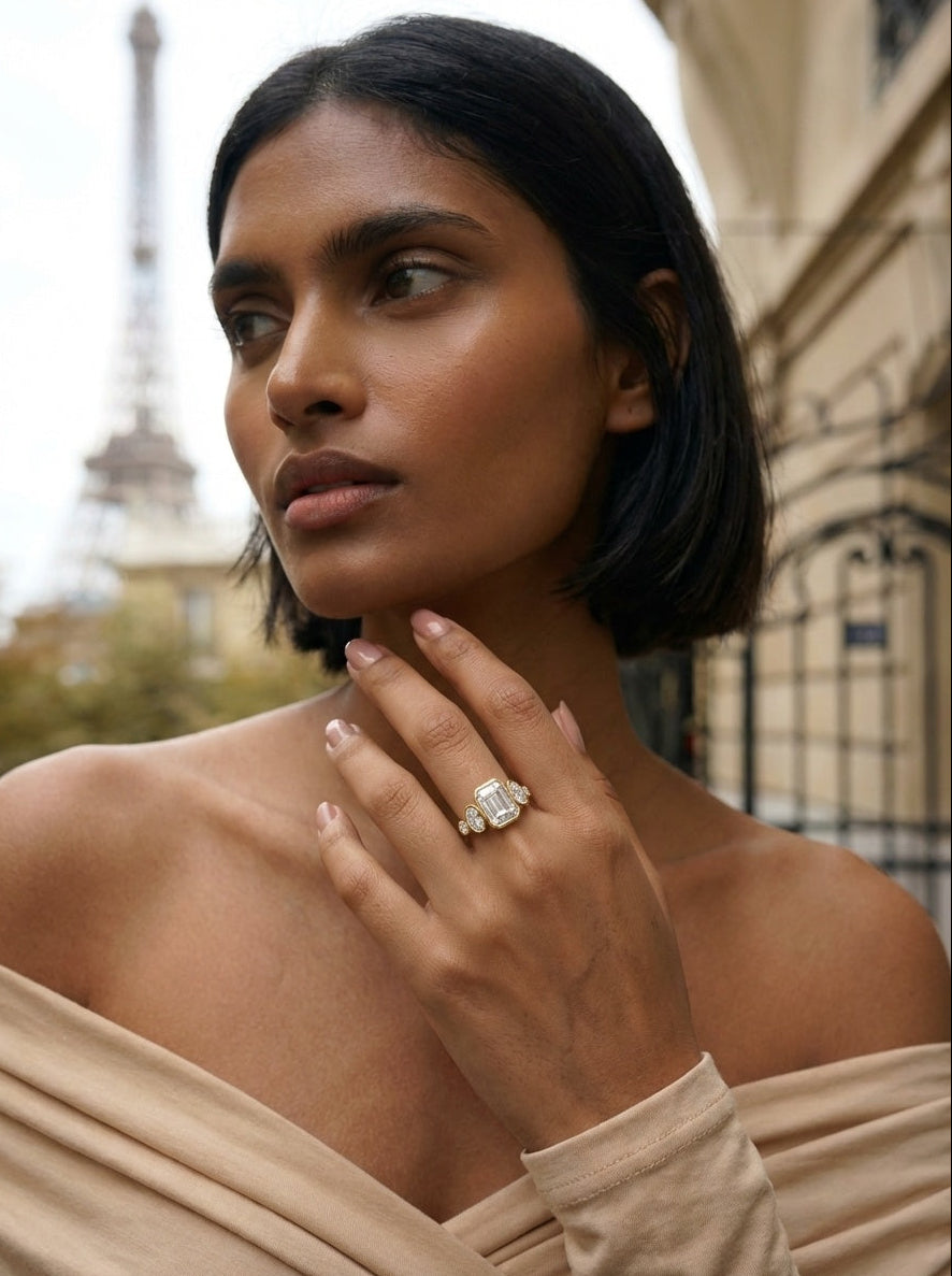 Woman wearing a diamond ring with the Eiffel Tower in the background
