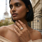 Woman wearing a diamond ring with the Eiffel Tower in the background